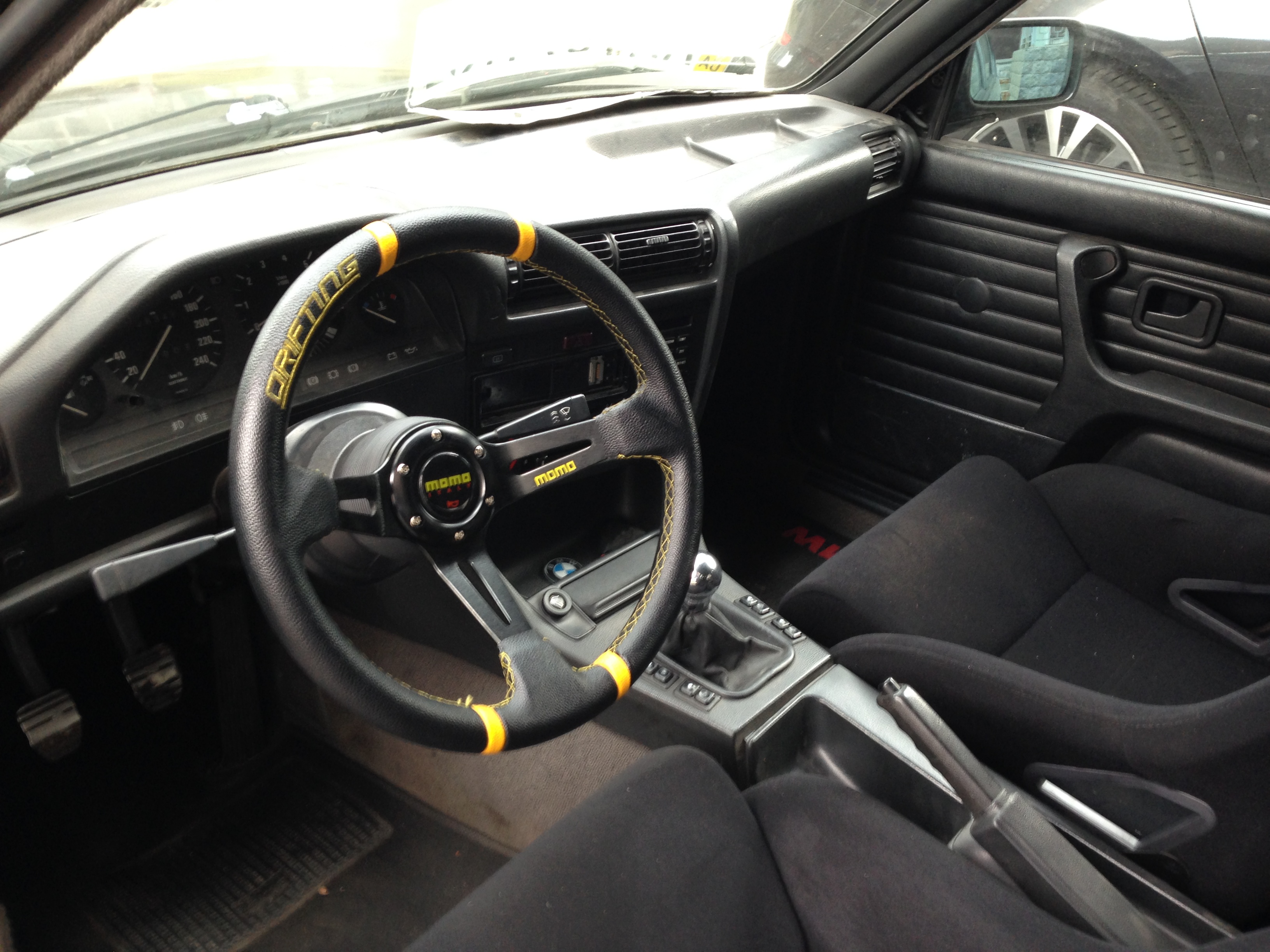E30 interior with MOMO steering wheel and bucket seats